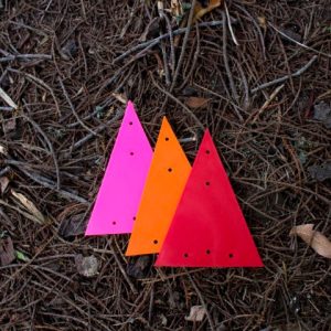 Small, plastic triangle markers in bright pink, orange, and red.