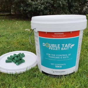 Double Tap pellet bait to control possums and rats - a container with some pellets sitting on the lid.